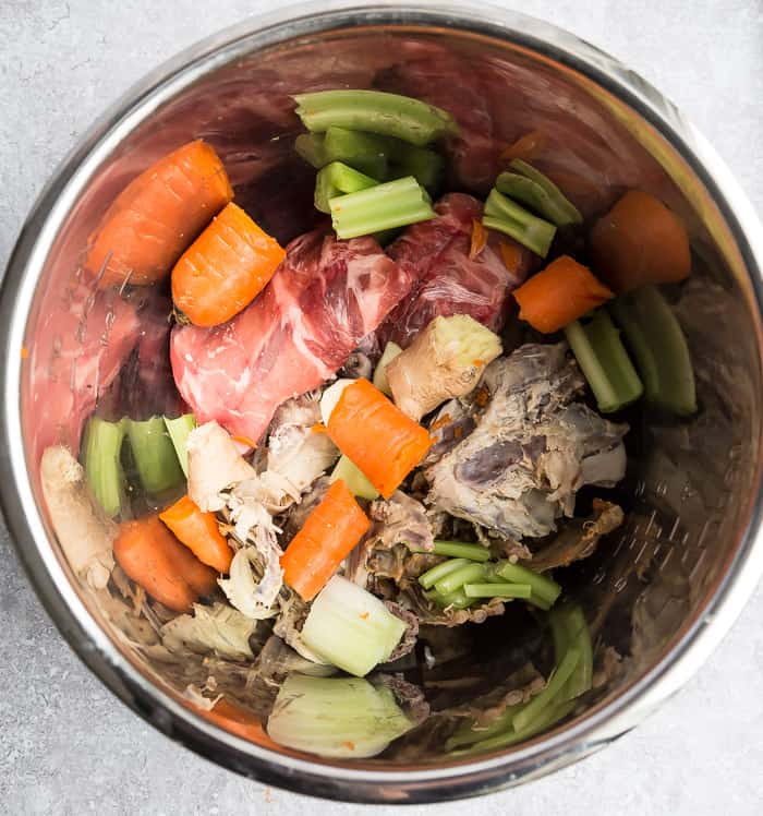 Silver mixing bowl with ingredients to make Instant Pot bone broth