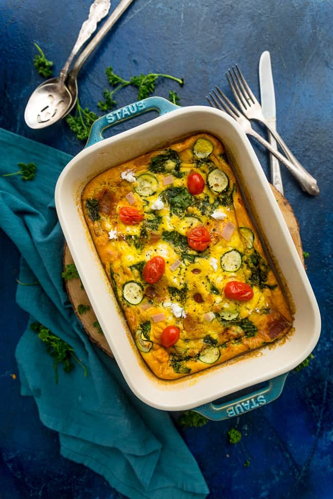 Top view of egg casserole in a casserole dish on a blue background