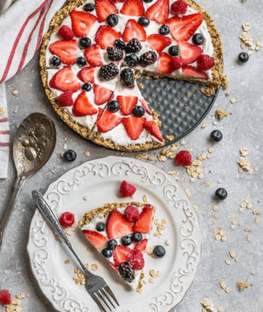 Overhead view of Breakfast Pizza with fresh berries next to a slice on a plate