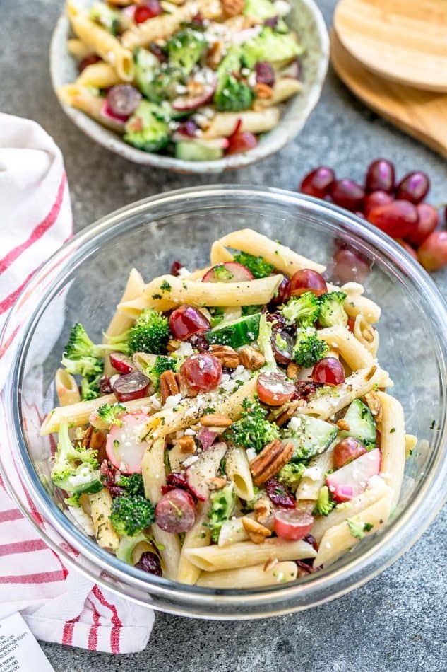 Top view of Broccoli Pasta Salad with grapes and pecans in a glass bowl
