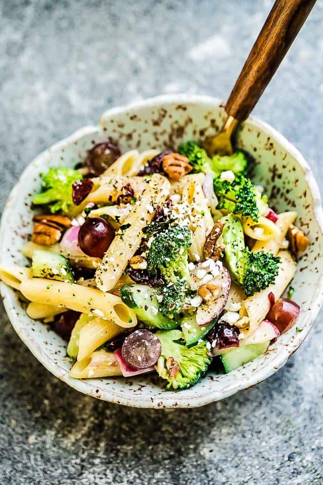 Top view of a serving of Broccoli Pasta Salad with grapes and pecans in a bowl