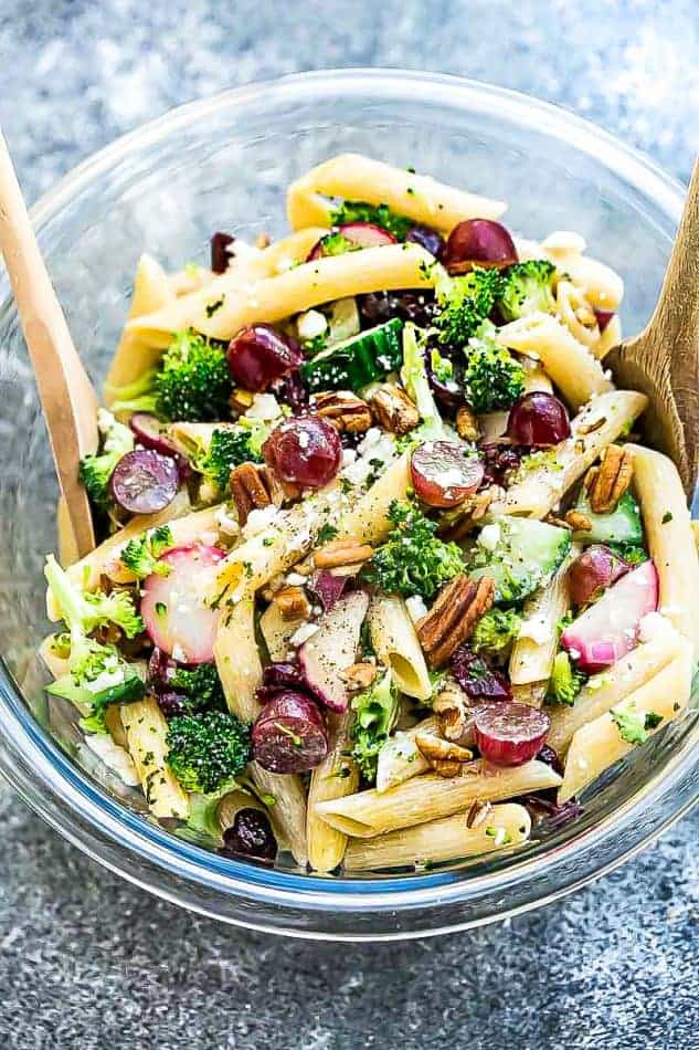 Top view of Broccoli Pasta Salad with grapes and pecans in a glass bowl