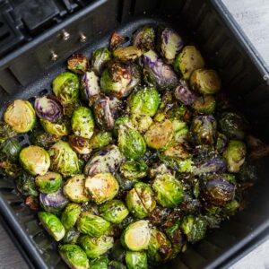 Top view of air fried Brussels sprouts in an air fryer basket