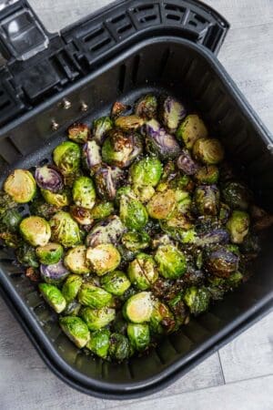 Top view of air fried Brussels sprouts in an air fryer basket