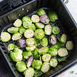 Top view of raw Brussels sprouts in an air fryer basket
