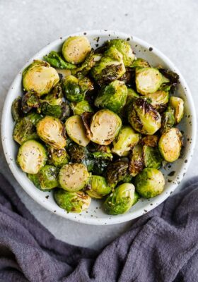 Top view of cooked Brussels sprouts in a white bowl