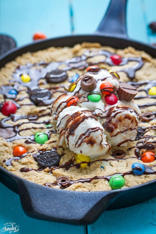Candy Oreo Monster Skillet Cookie Pizza in a cast-iron skillet topped with candy and ice cream
