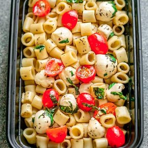 Caprese Pasta Salad - the perfect side dish to bring to summer potlucks, parties, Memorial Day / Fourth of July grillouts/barbecues. Best of all, it's so easy to make and easy to customize with your favorite toppings and homemade dressing. Perfect for Sunday meal prep and leftovers are delicious for school or work lunchboxes or lunchbowls.