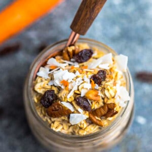 Top view of carrot cake overnight oats in a jar with a spoon