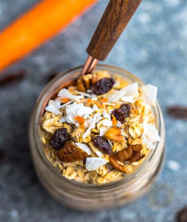 Top view of carrot cake overnight oats in a jar with a spoon