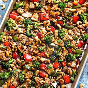 Top view of a sheet pan of Cashew Chicken and vegetables