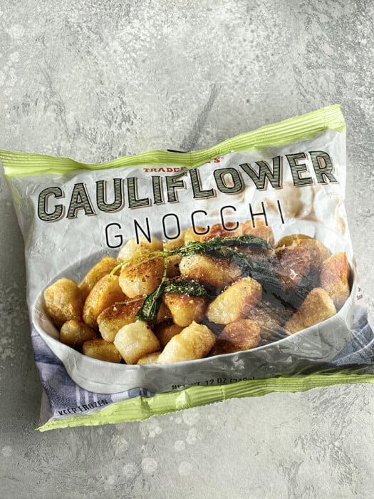 A package of Trader Joe's Cauliflower Gnocchi on a grey background