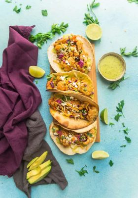 Roasted Cauliflower Tacos - an easy 30 minute vegetarian meal with bold and smoky Tex Mex flavors and a deliciously tasty avocado cream. Seasoned cauliflower with crispy roasted edges, red cabbage slaw, & lime you’ll never miss the meat for your next Mexican fiesta or Taco Tuesday. Low carb / keto options.