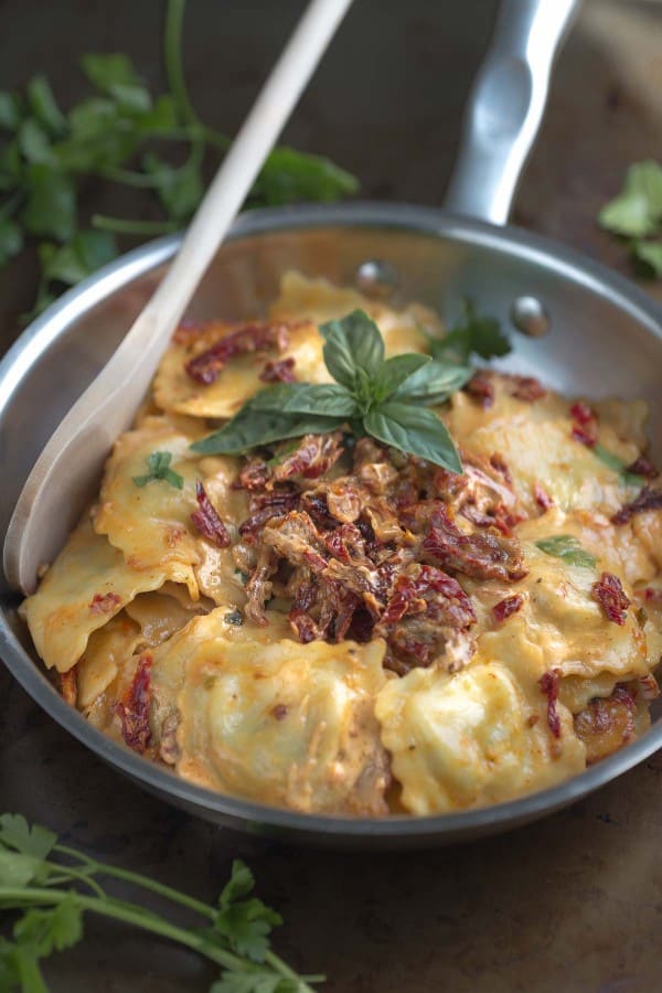 Cheese Ravioli with a Skinny Sun-Dried Tomato Alfredo Sauce in a skillet