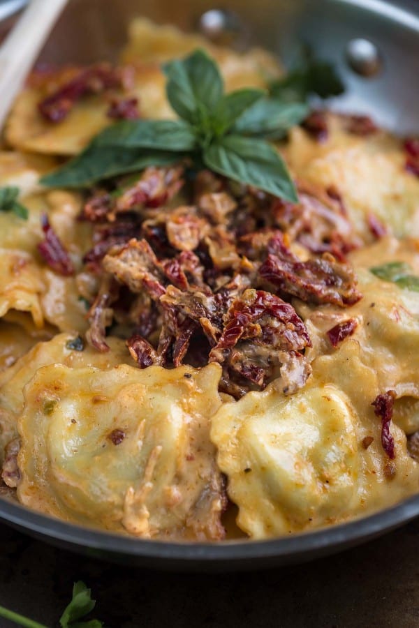 Close-up of Cheese Ravioli with a Skinny Sun-Dried Tomato Alfredo Sauce in a skillet