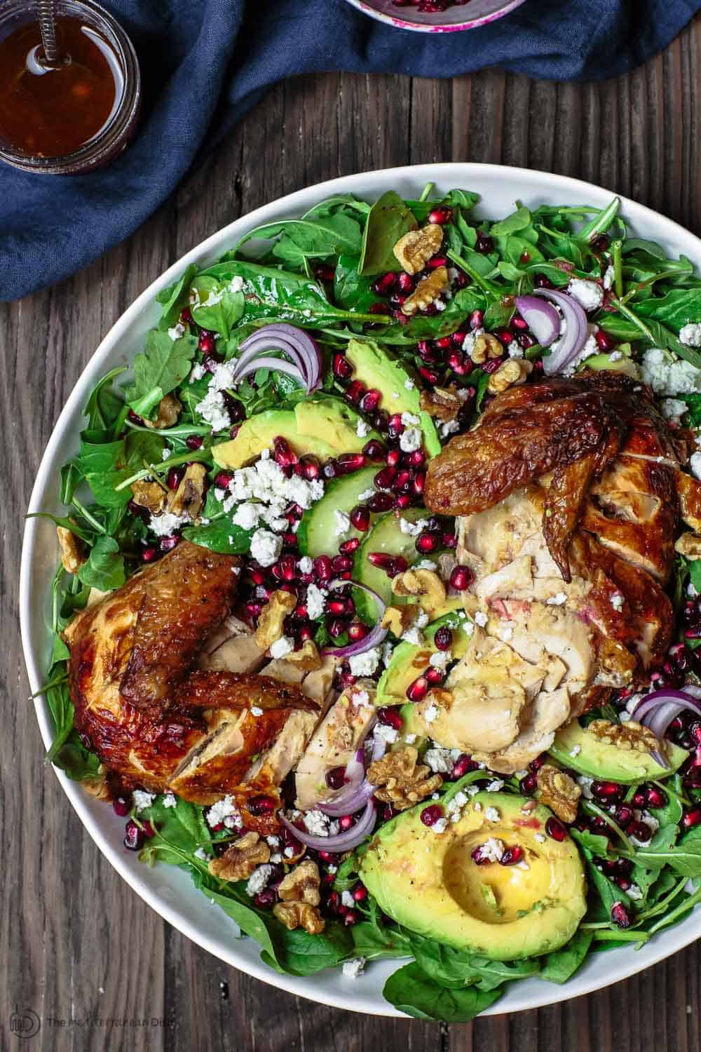 Overhead view of Chicken Arugula Salad with avocado and pomegranate