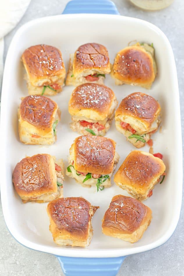 Top view of a dozen Italian Chicken Bruschetta Sliders in a rectangular baking dish