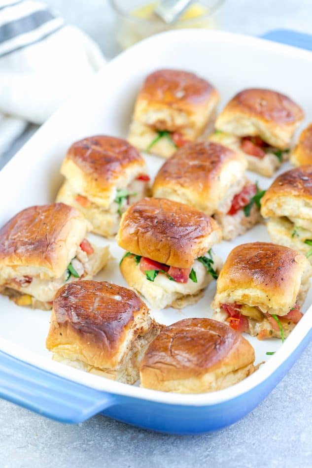 A dozen Italian Chicken Bruschetta sliders in a rectangular baking dish