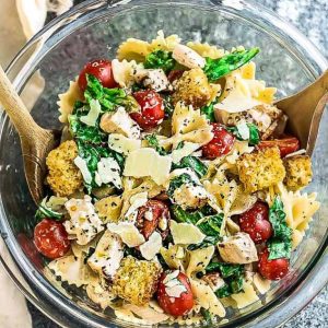 Top view of Chicken Caesar Pasta Salad in a glass bowl