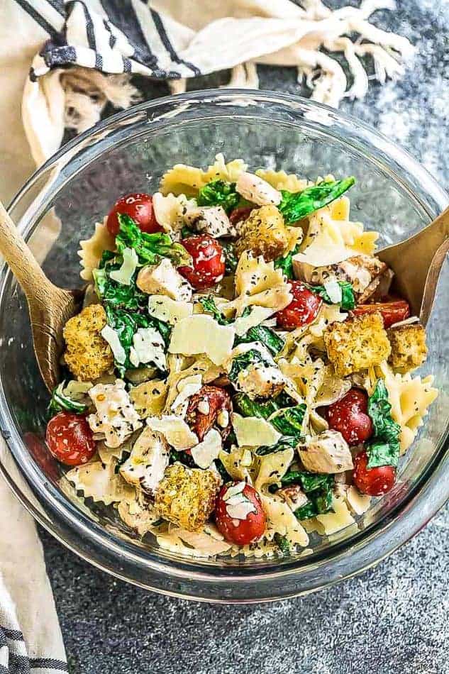 Top view of chicken Caesar pasta salad in glass bowl