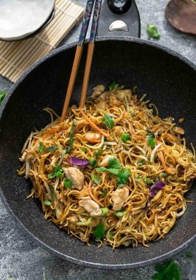Top view of Chicken Chow Mein in a wok with chopsticks