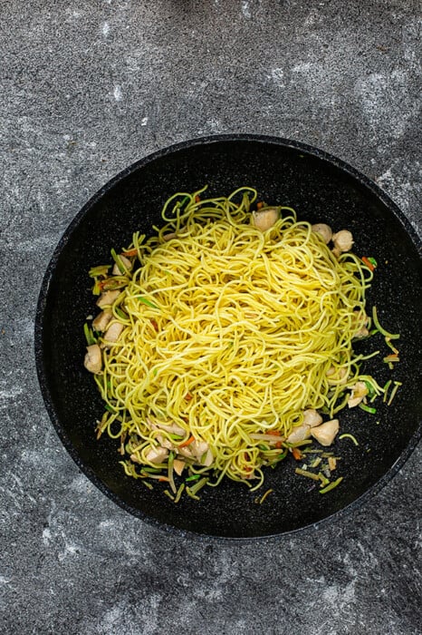 Top view of chow mein noodles in a wok