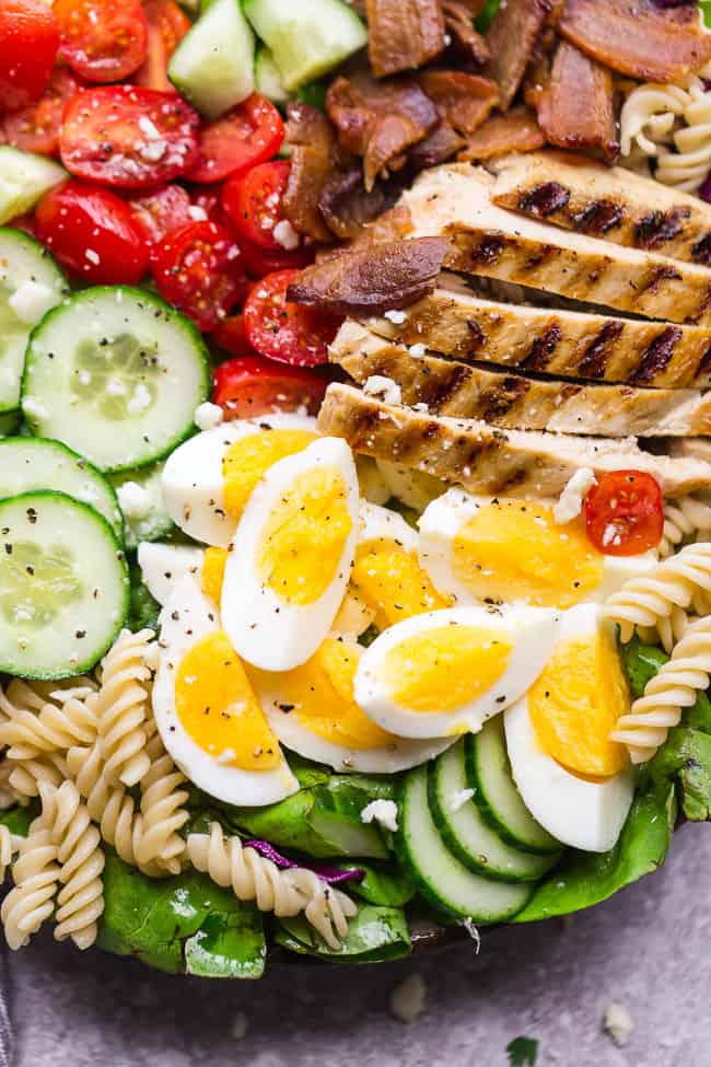 Cobb Pasta Salad - an easy side dish perfect for summer parties, picnics, potlucks and BBQ's. Made with bacon, avocado, grilled chicken, tomatoes, hard-boiled eggs, cheese, and a homemade ranch dressing.