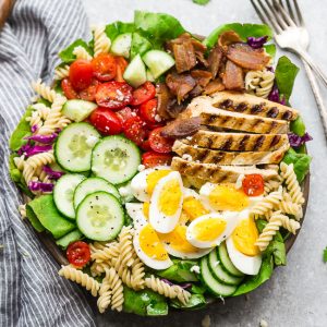 Cobb Pasta Salad - an easy side dish perfect for summer parties, picnics, potlucks and BBQ's. Made with bacon, cucumbers, grilled chicken, tomatoes, hard-boiled eggs, cheese, and a homemade ranch dressing.