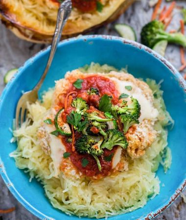 Chicken Parmesan Spaghetti Squash Bowls make the perfect easy one pan meal. Best of all, it's so easy to customize with your favorite veggies and takes just 15 minutes of prep time!