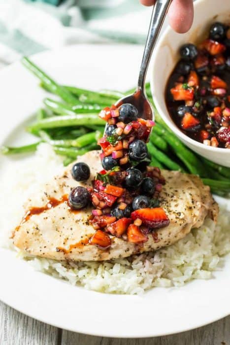Grilled chicken over rice topped with blueberry salsa