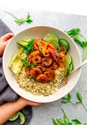 Chili Lime Shrimp Fajita Bowls are the perfect healthy meal for spring or summer. Best of all, they're low carb, paleo, whole 30, keto-friendly and easy to customize and made with cauliflower rice, bell peppers and avocado.