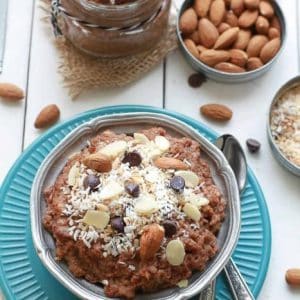 Top view of a bowl of Chocolate Coconut Almond Overnight Oats next to ingredients