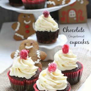 Chocolate Gingerbread Cupcakes with gingerbread cookies nearby