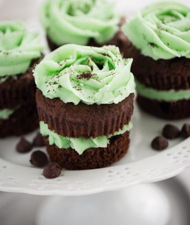 Sandwich-style Chocolate Mint Cupcakes on a white cake stand