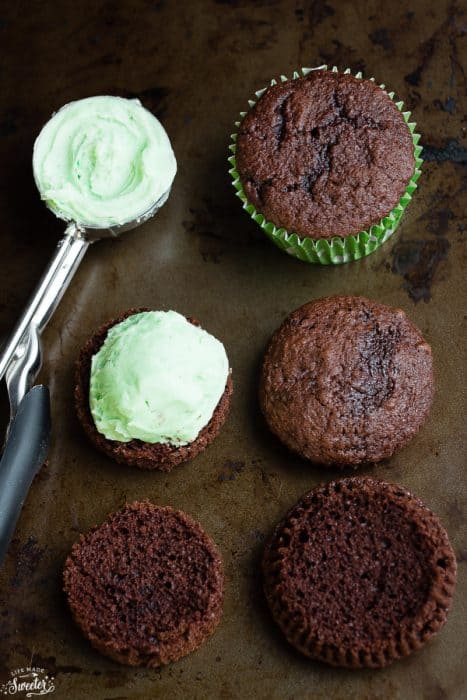 Mint frosting being added to chocolate cupcakes
