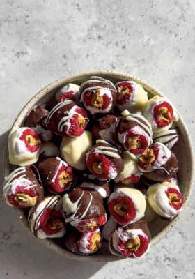 A pile of chocolate stuffed raspberries in a bowl .