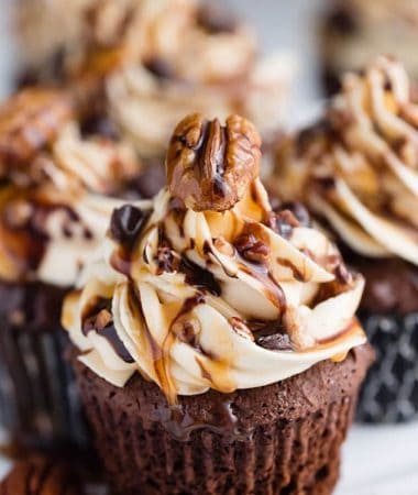 Chocolate Turtle Cupcakes make the perfect decadent treat! Best of all, they come together easily packed with salted caramel frosting, crunchy pecans, sweet chocolate chips and an extra drizzle of caramel sauce! So delicious!