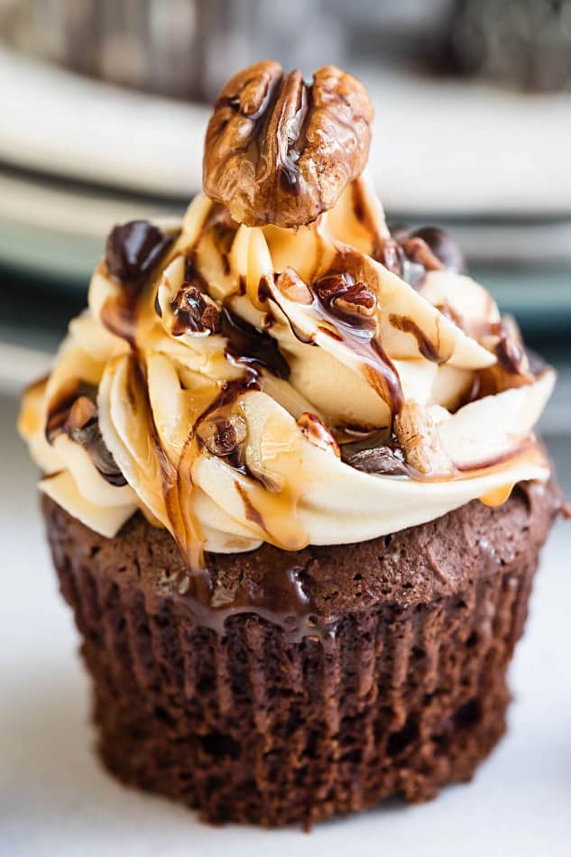 Chocolate Turtle Cupcakes make the perfect decadent treat! Best of all, they come together easily packed with salted caramel frosting, crunchy pecans, sweet chocolate chips and an extra drizzle of caramel sauce! So delicious!