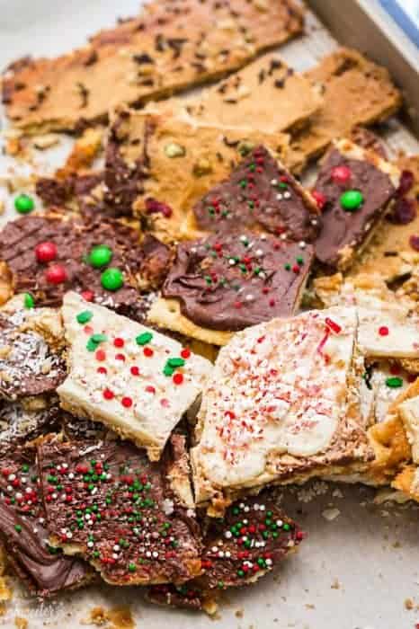 Top view of christmas crack in 7 variations on a baking sheet