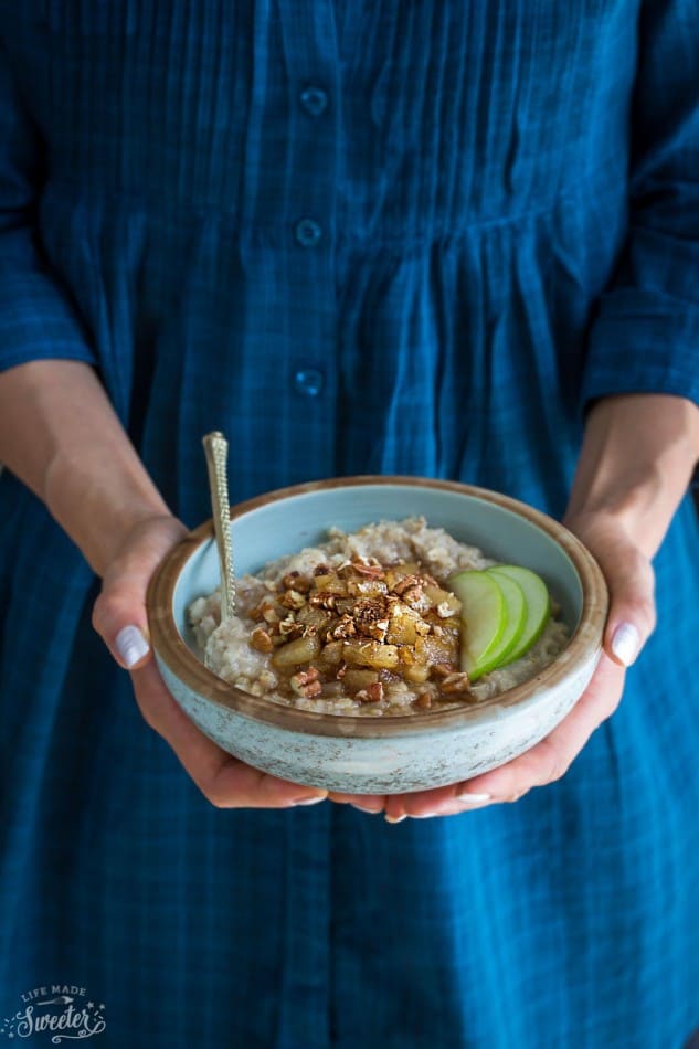 Front view of cinnamon apple oatmeal being held in two hands.