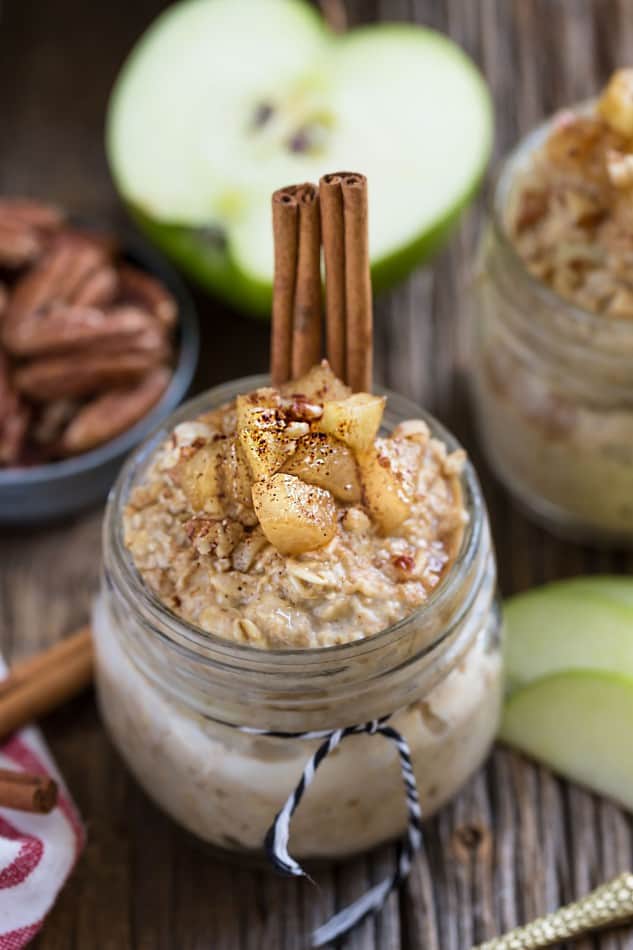 A jar of Cinnamon Apple Pie Overnight Oats with cinnamon sticks