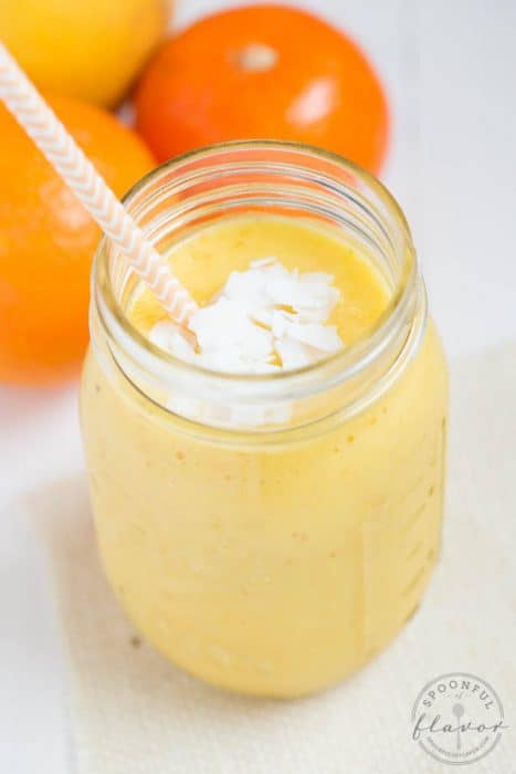 Citrus Sunrise Smoothie in a jar topped with coconut