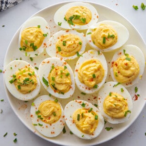 Top view of 11 Deviled eggs on a white plate