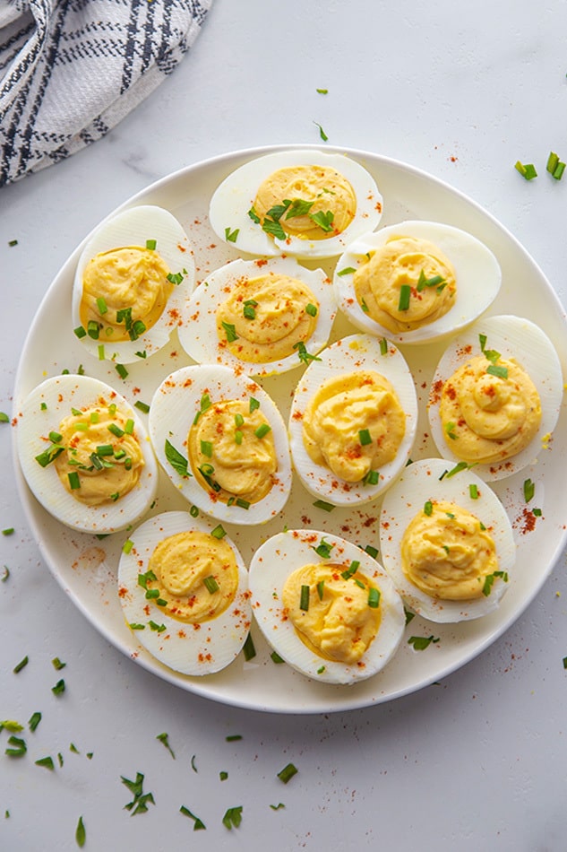 Overhead view of deviled eggs on a white plate