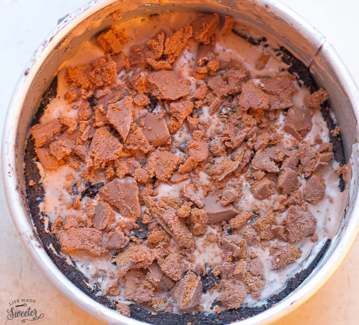 Top view of cookies and cream cake being assembled in pan.