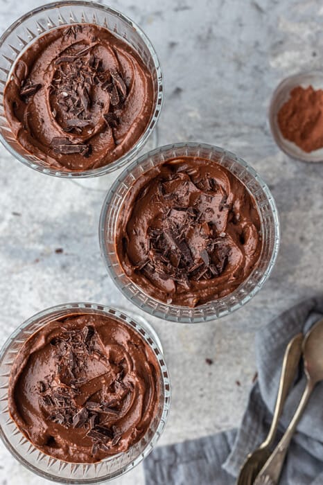 Chocolate avocado mousse in three glass jars