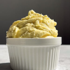 Side shot of a serving of pineapple sorbet in a white ramekin bowl