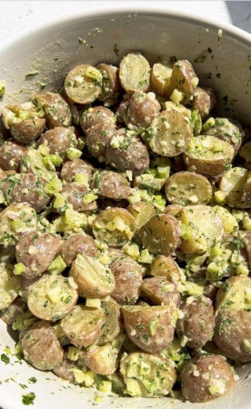 Tossed potato salad in a mixing bowl