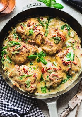 6 Chicken Thighs simmered in a creamy sun-dried tomato sauce in a large skillet
