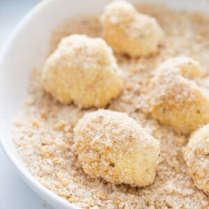 Raw cauliflower florets covered in an almond meal breading mixture